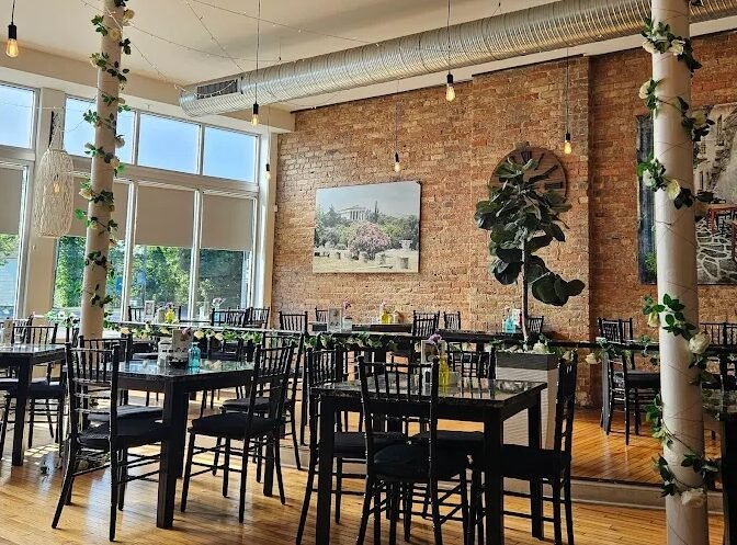 Empty dining room at Eggsperience Vasilis prepared for service.